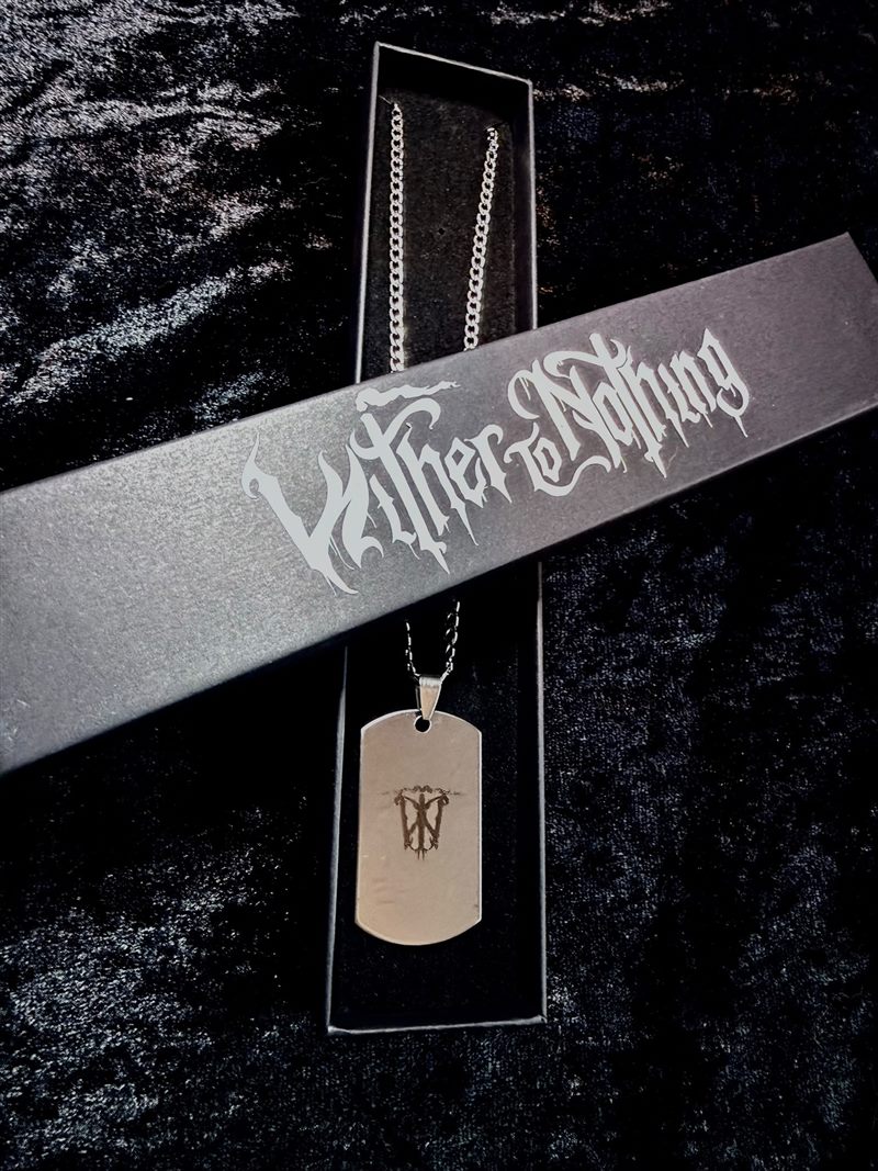 Necklace resting on the Wither To Nothing box